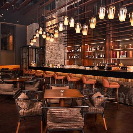 Al Jaddaf Rotana Suite Hotel Dubai Esterno foto The bar at the hotel
