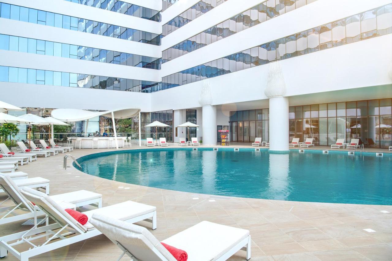 Al Jaddaf Rotana Suite Hotel Dubai Esterno foto The pool at the hotel